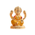 Golden idol of Goddess Lakshmi, seated and holding two lotus flowers, symbolizing wealth and prosperity.