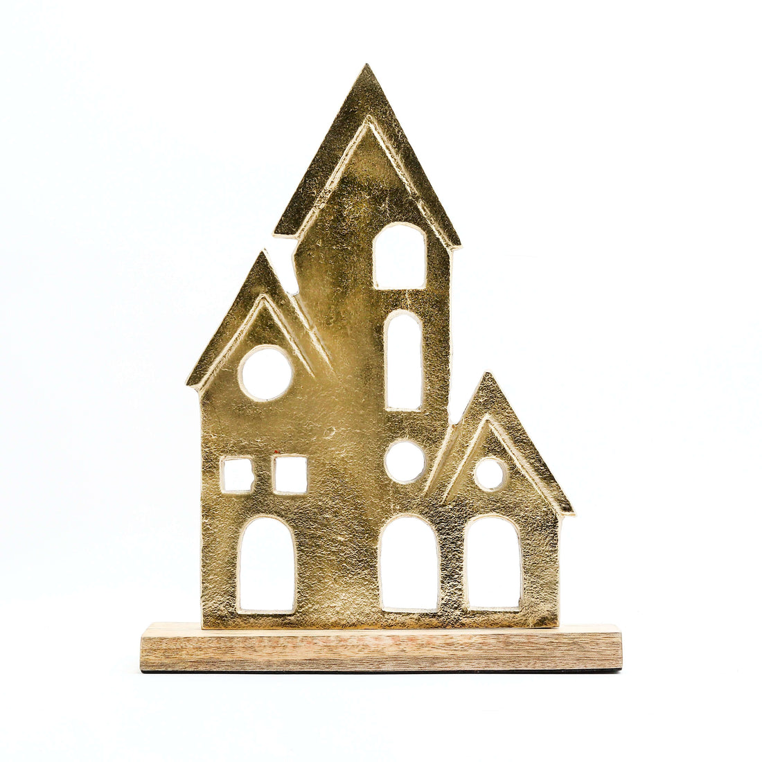 A gold-colored elegant home decor figurine of a house is featured on a light-colored wooden base. The figurine has a textured, matte finish and is composed of three interconnected house-like shapes of varying sizes, each with pointed roofs and several stylized window and door cutouts. The item is displayed against a white background.