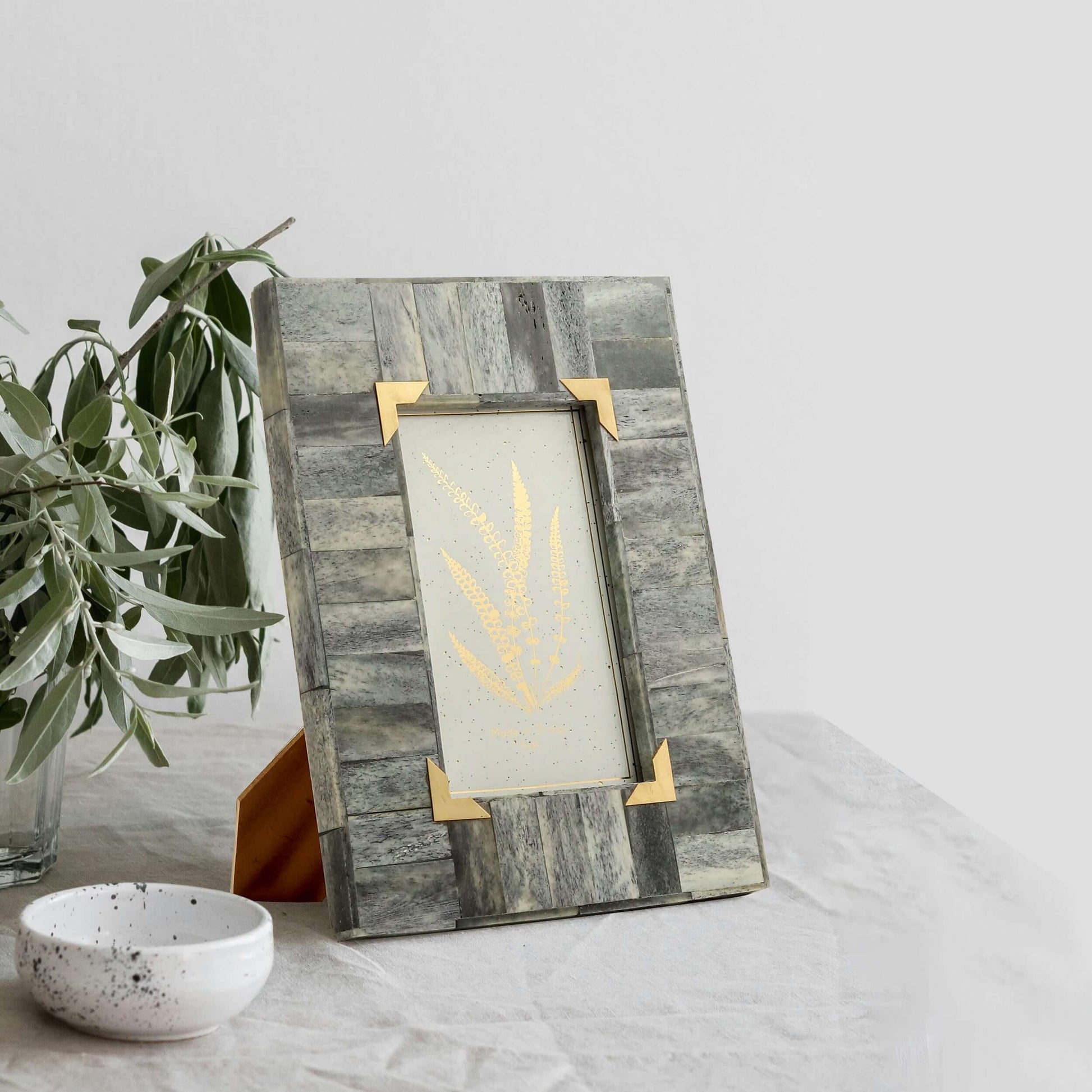 Grey and Gold frame on the desk