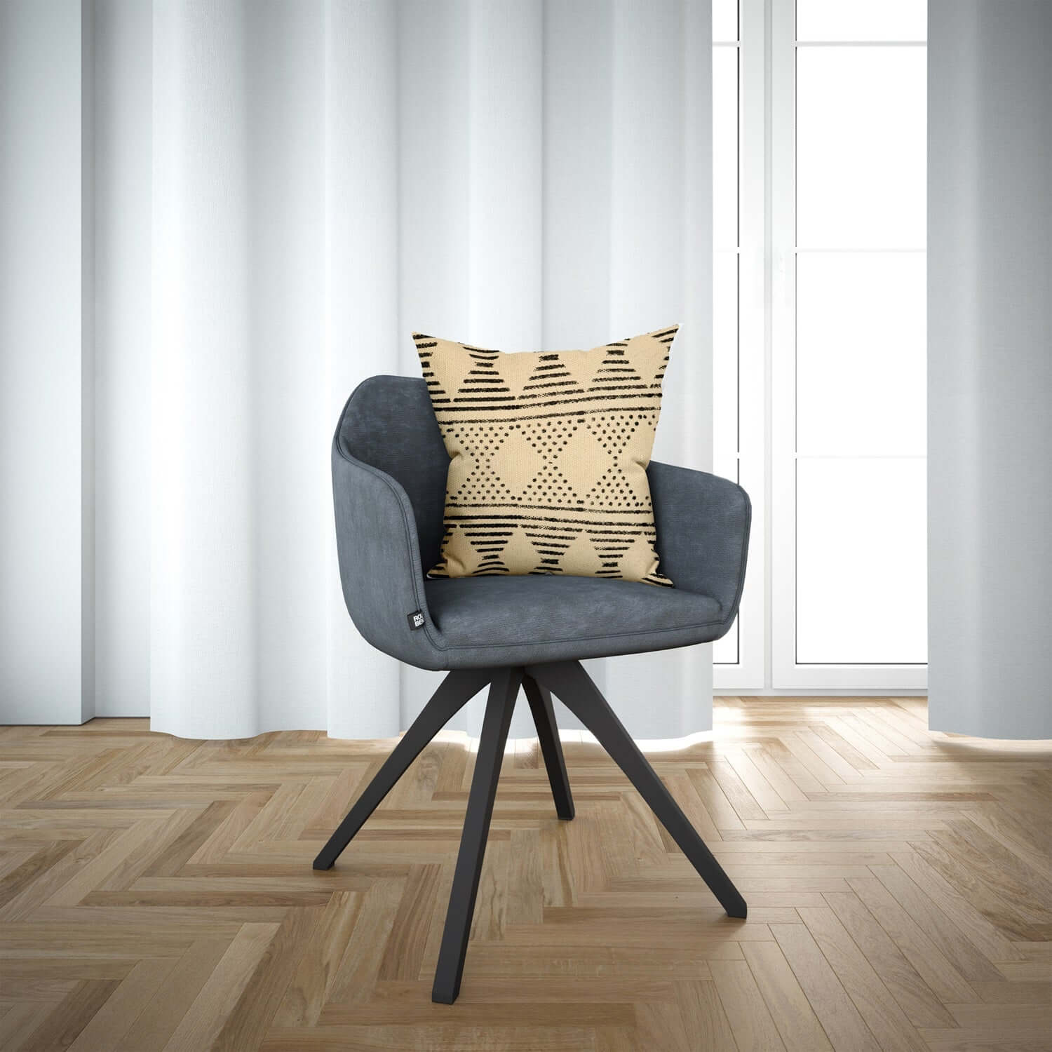 A beige and black tribal motif pillow cover on a gray chair