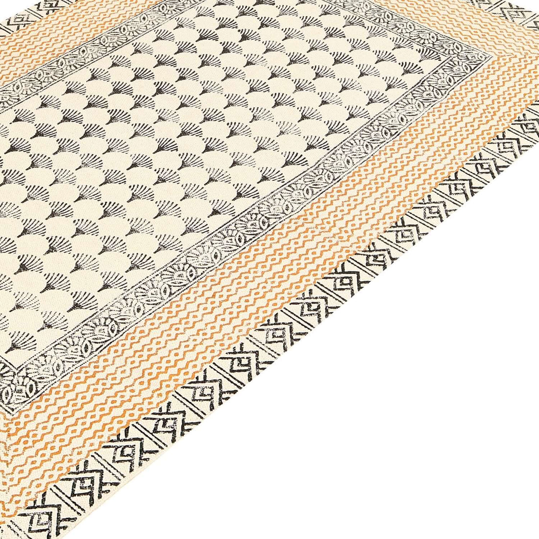 A rectangular rug with a boho-inspired geometric block-printed pattern in beige, black, and gray tones.