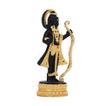 A black and gold statue of Ram Lalla (child Lord Rama) standing on a golden lotus base, adorned with a golden crown, ornate gold clothing, and holding a golden bow and arrow.