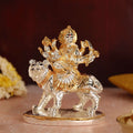 Gold and silver plated idol of Goddess Durga seated majestically on her lion mount.