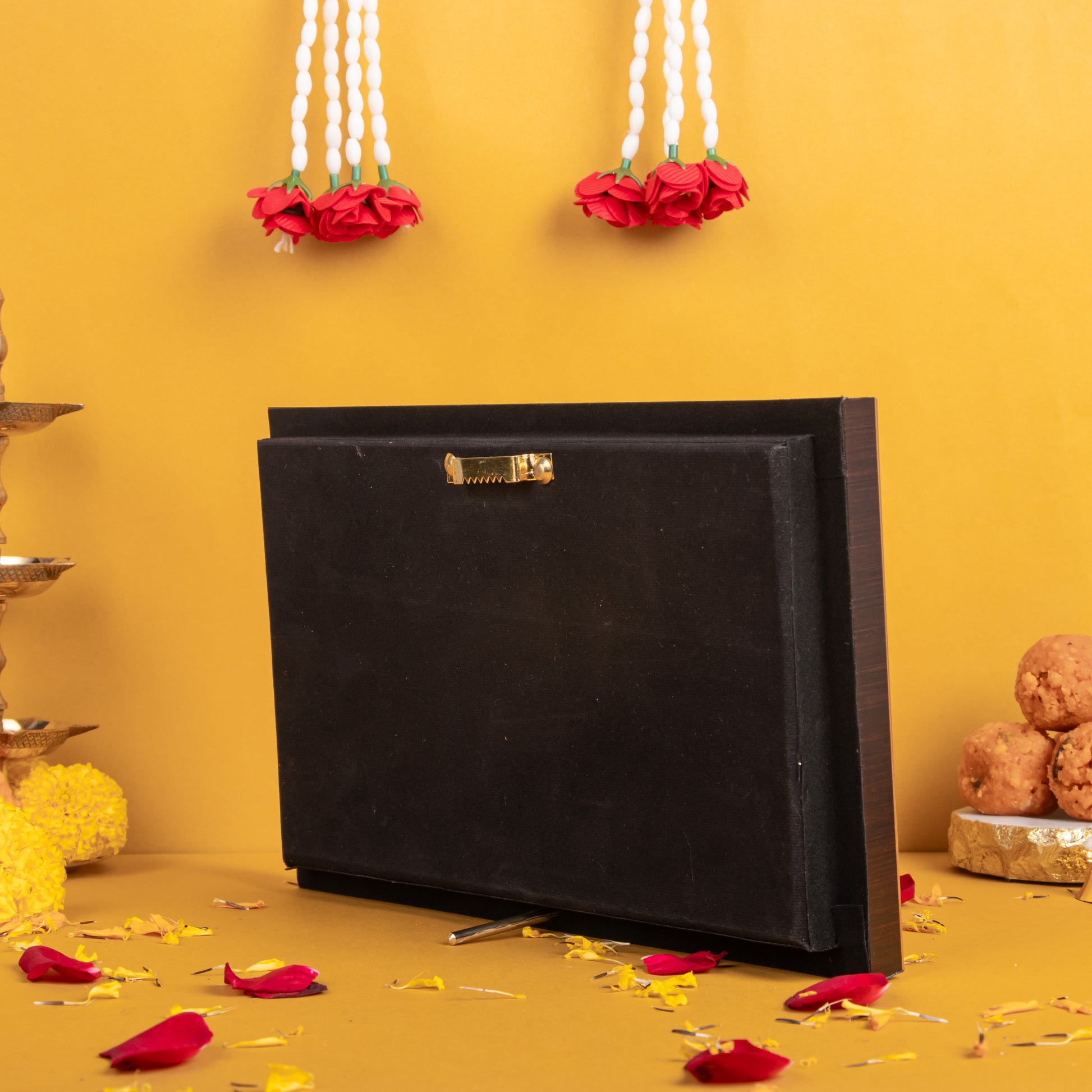 Back of a black photo frame with a sawtooth hanger for wall mounting and a kickstand for tabletop display, set against a golden background with decorative elements.