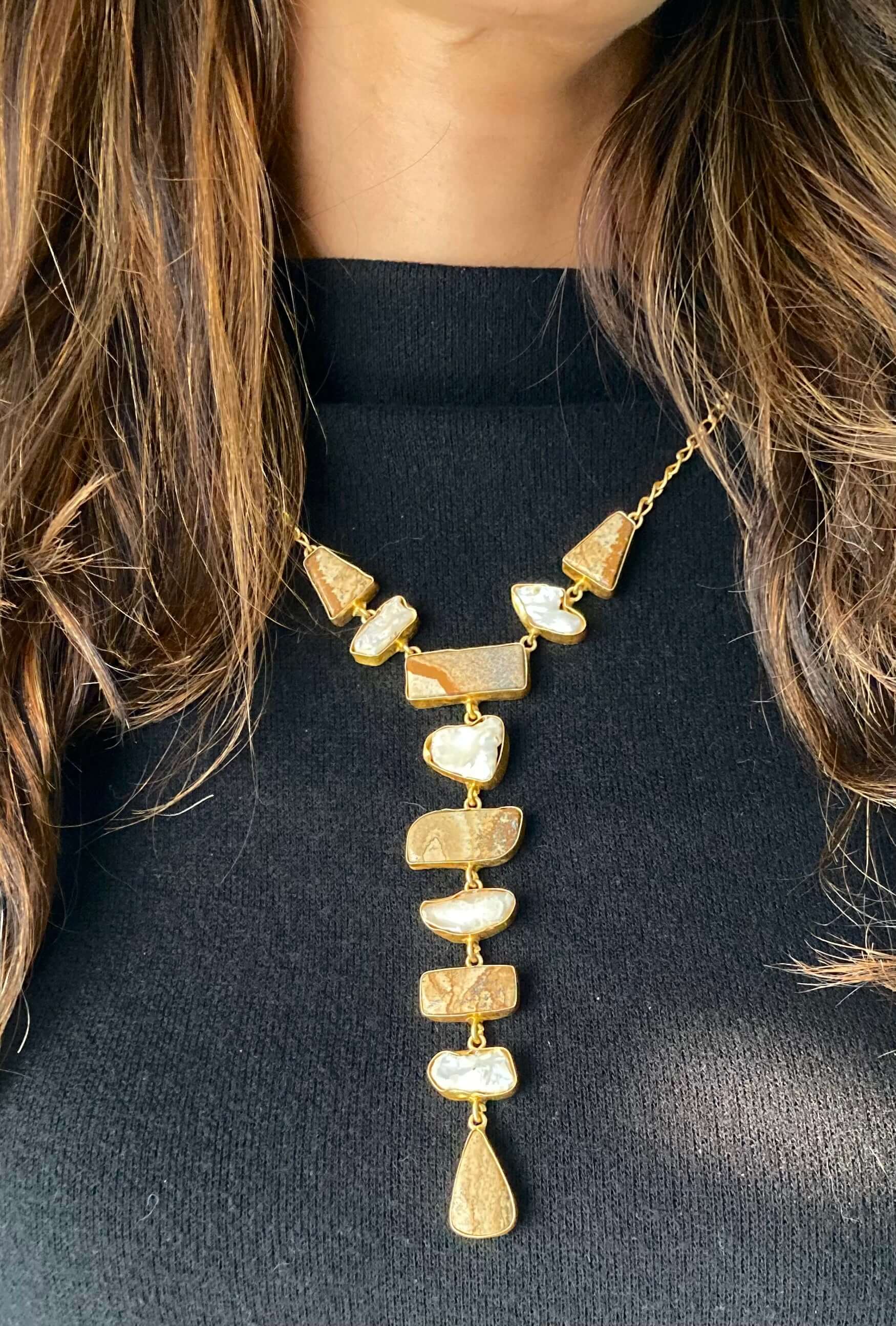 A long necklace with a multi-stone design featuring lime yellow beads, strung together on a chain.