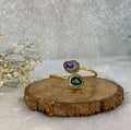 2 stone Grren and purple design adjustable cuff on the wooden base