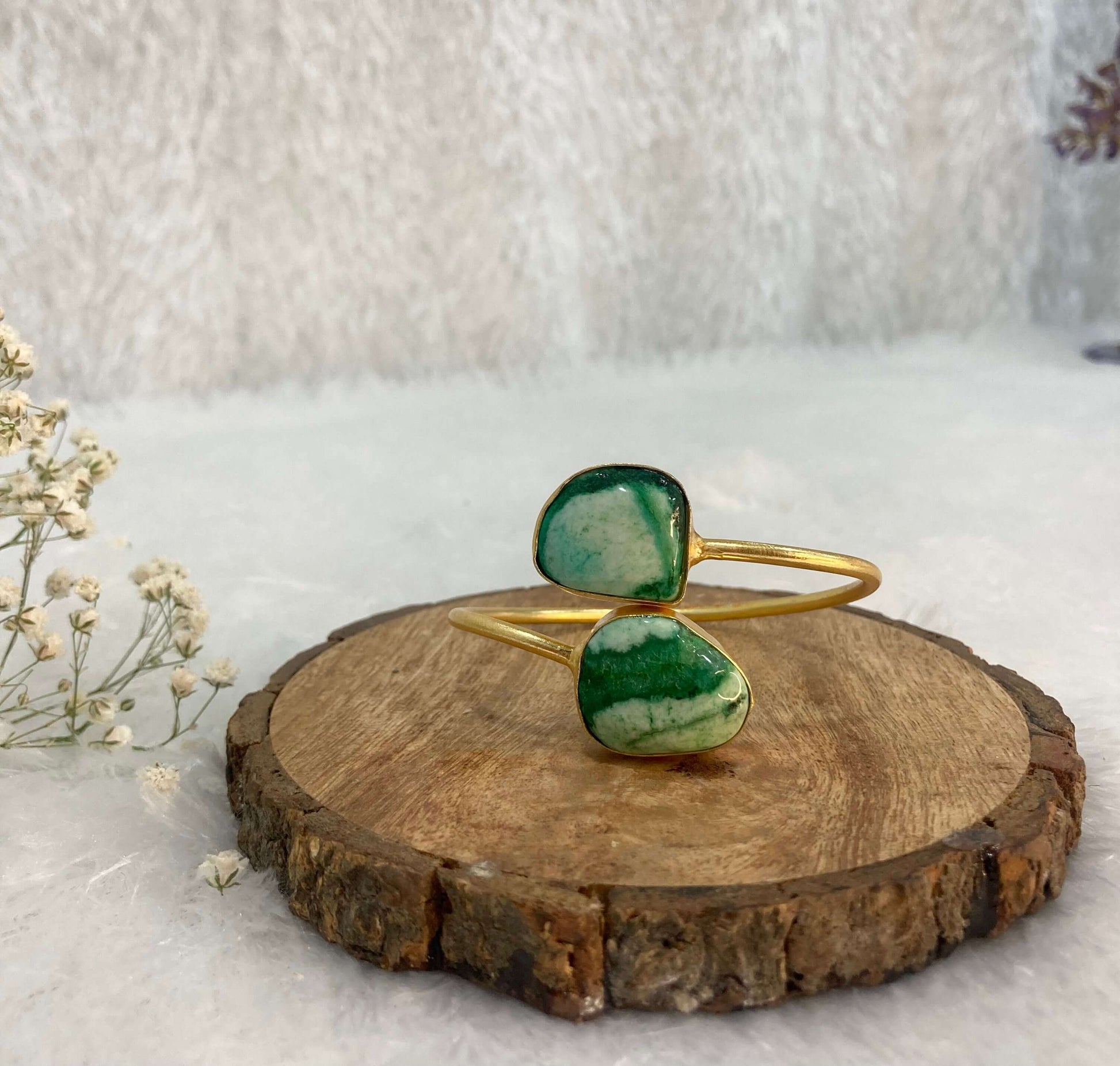 2 stone green adjustable cuff on the wooden base