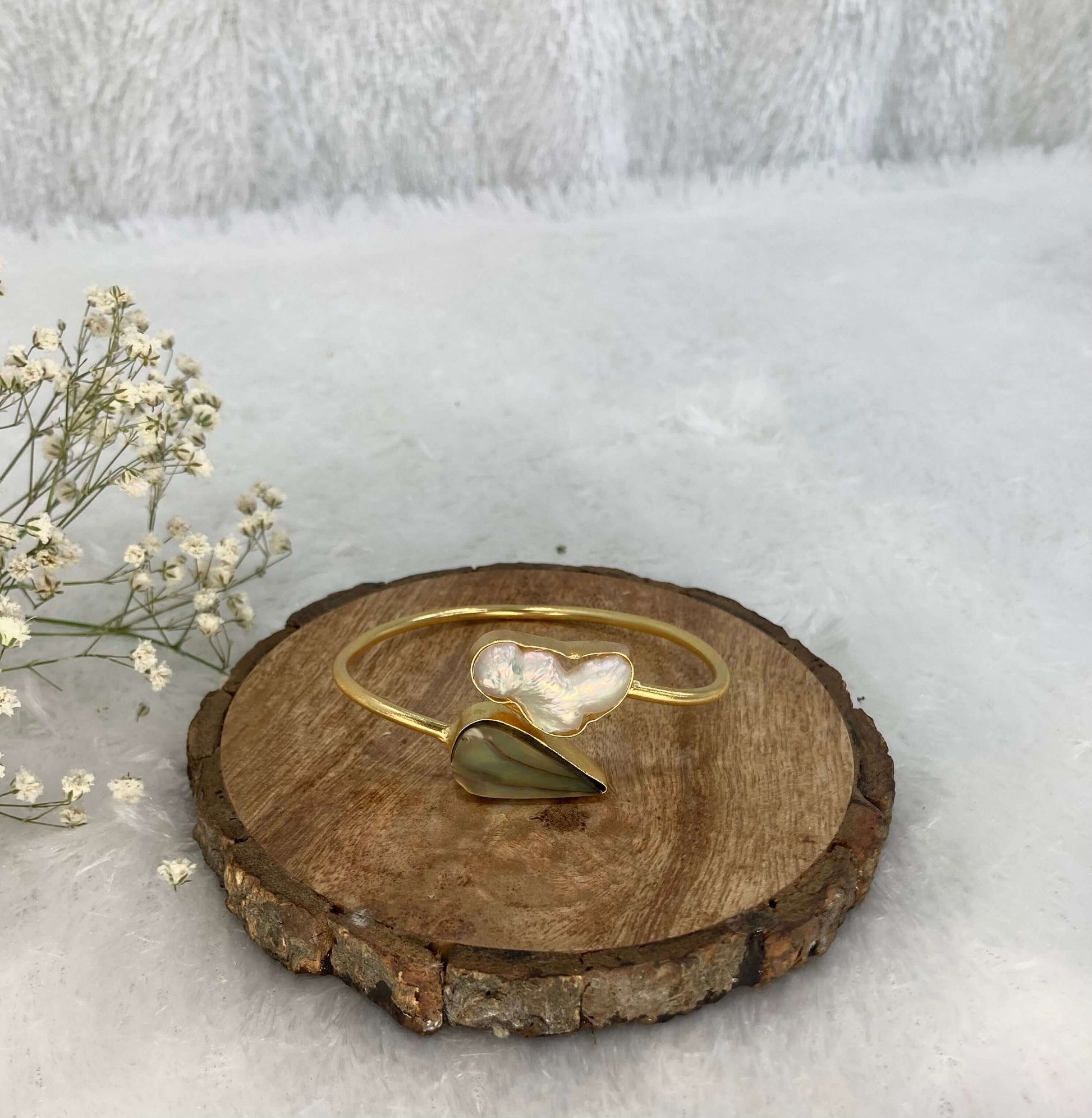 2 stone adjustable cuff on the wooden base