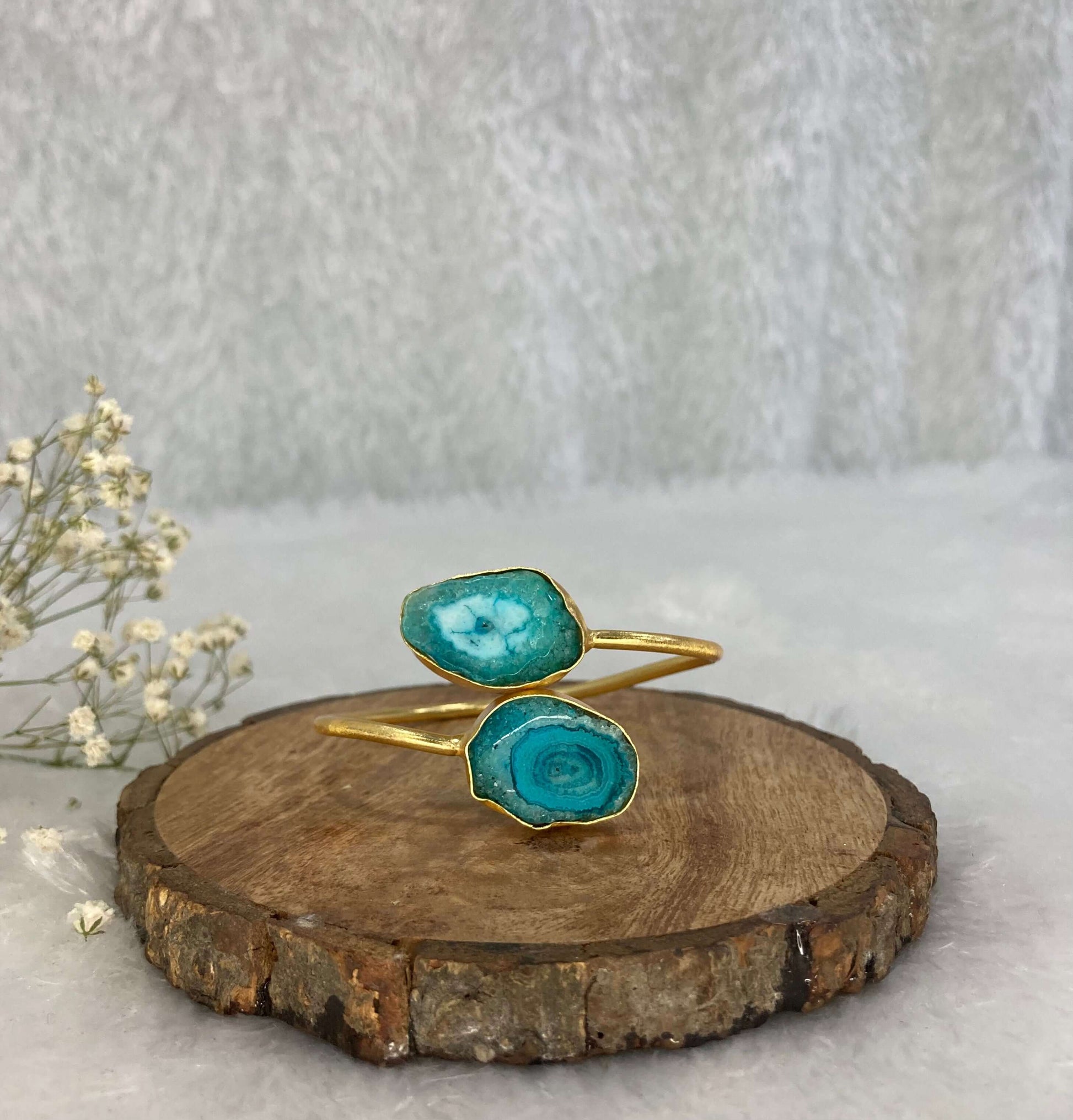 2 stone ocean Blue adjustable cuff on the wooden base