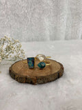white and multicolor Stone adjustable ear cuff on the wooden base
