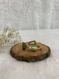 multicolor Stone adjustable ear cuff on the wooden base