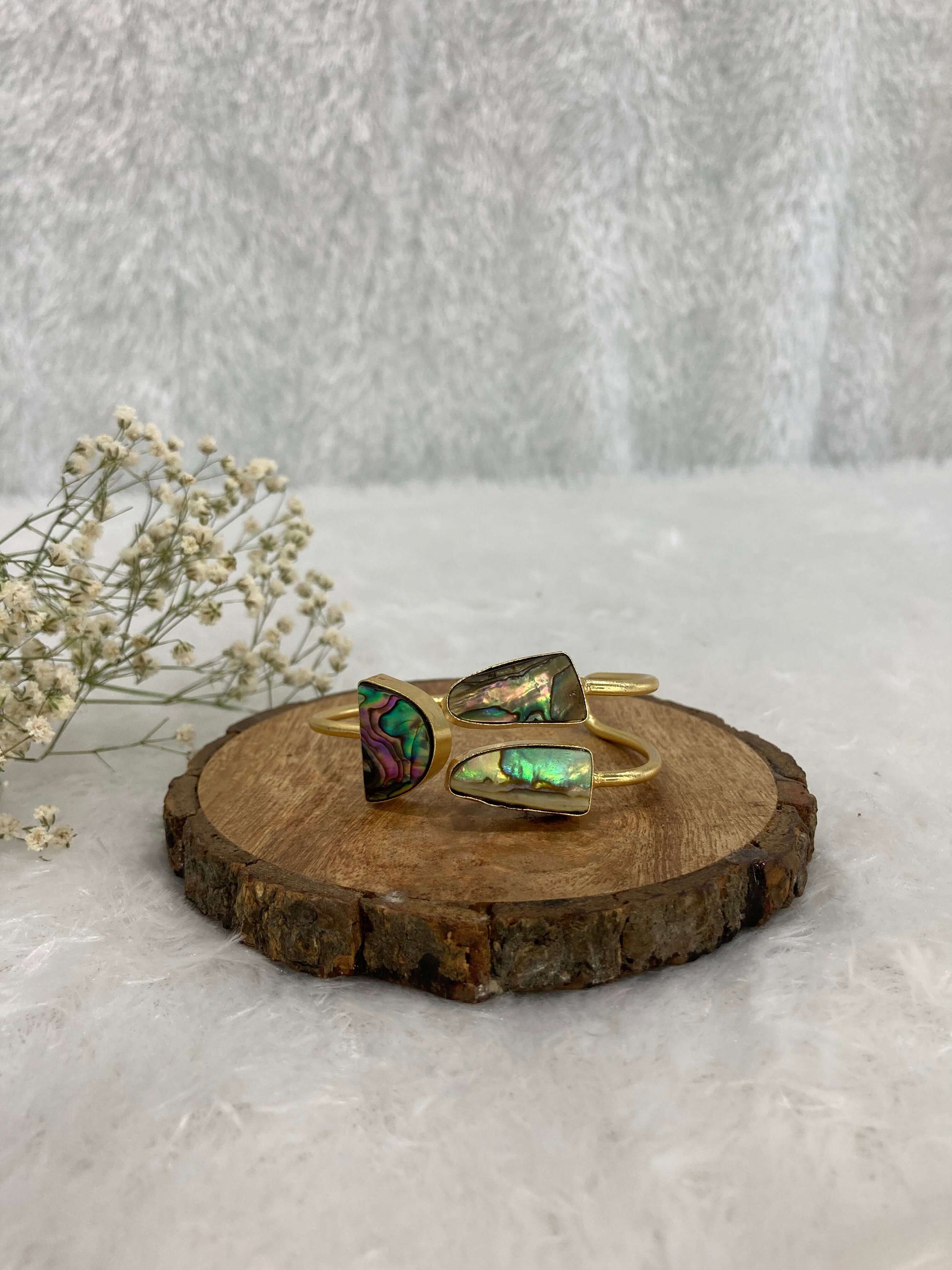 multicolor Stone adjustable ear cuff on the wooden base