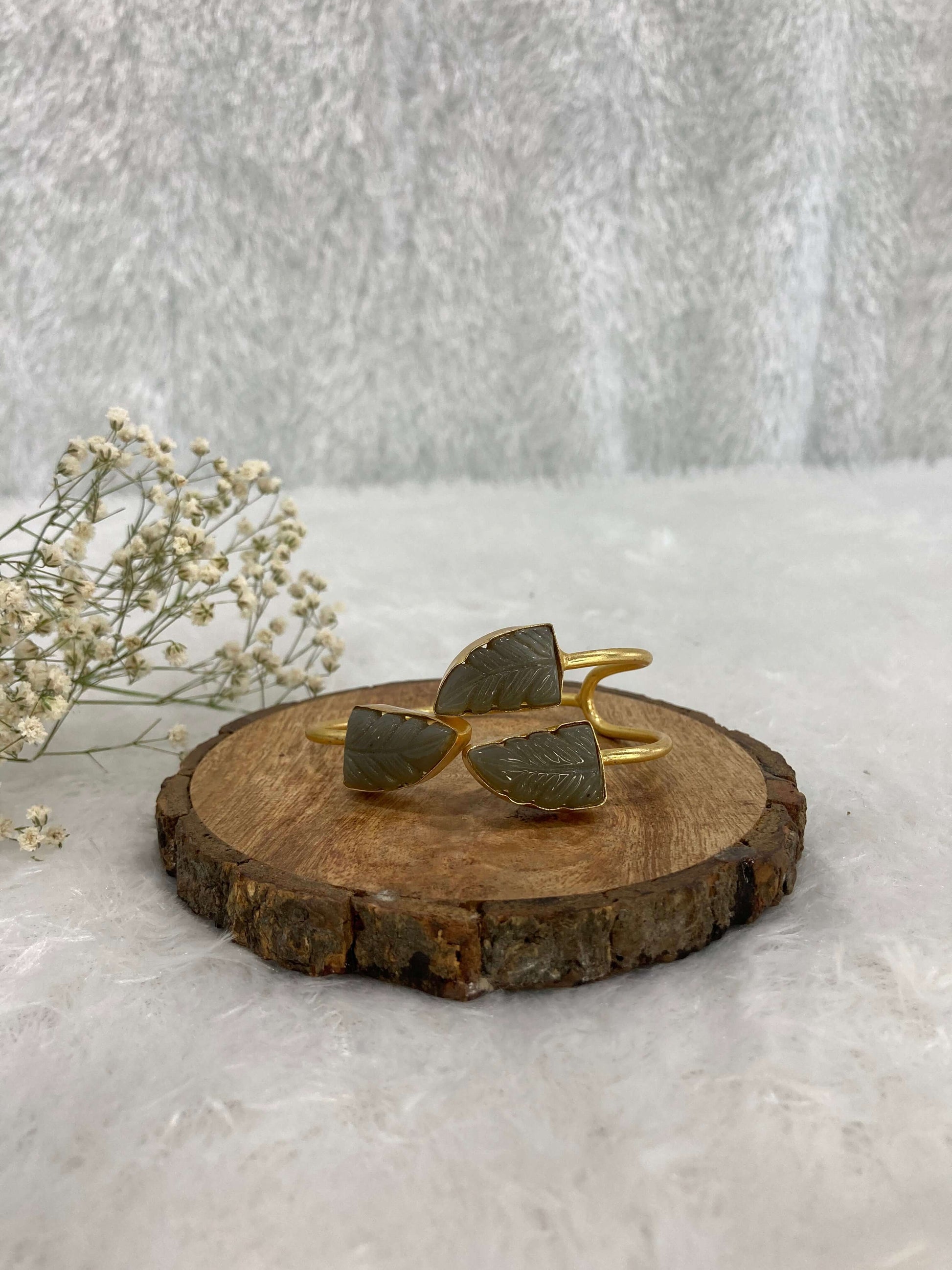 grey color Stone adjustable ear cuff on the wooden base