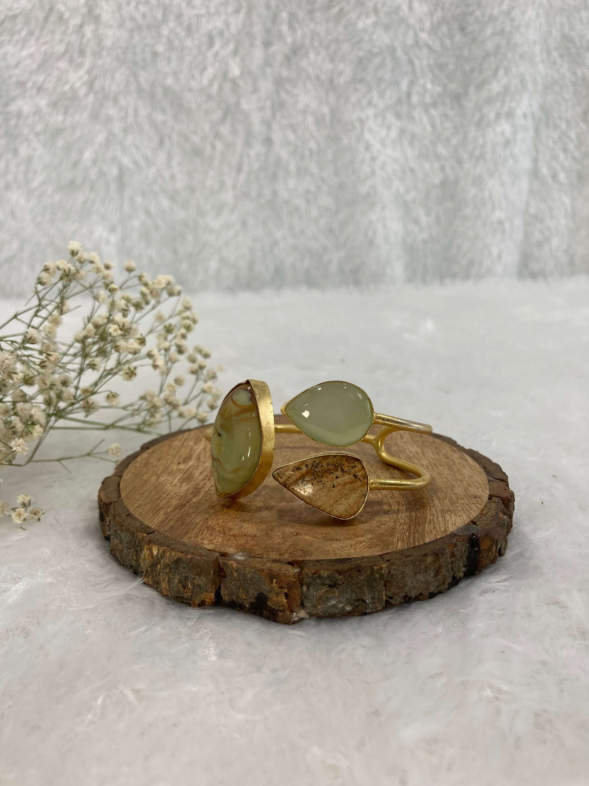 Water and wood color Stone ear cuff on the wooden base