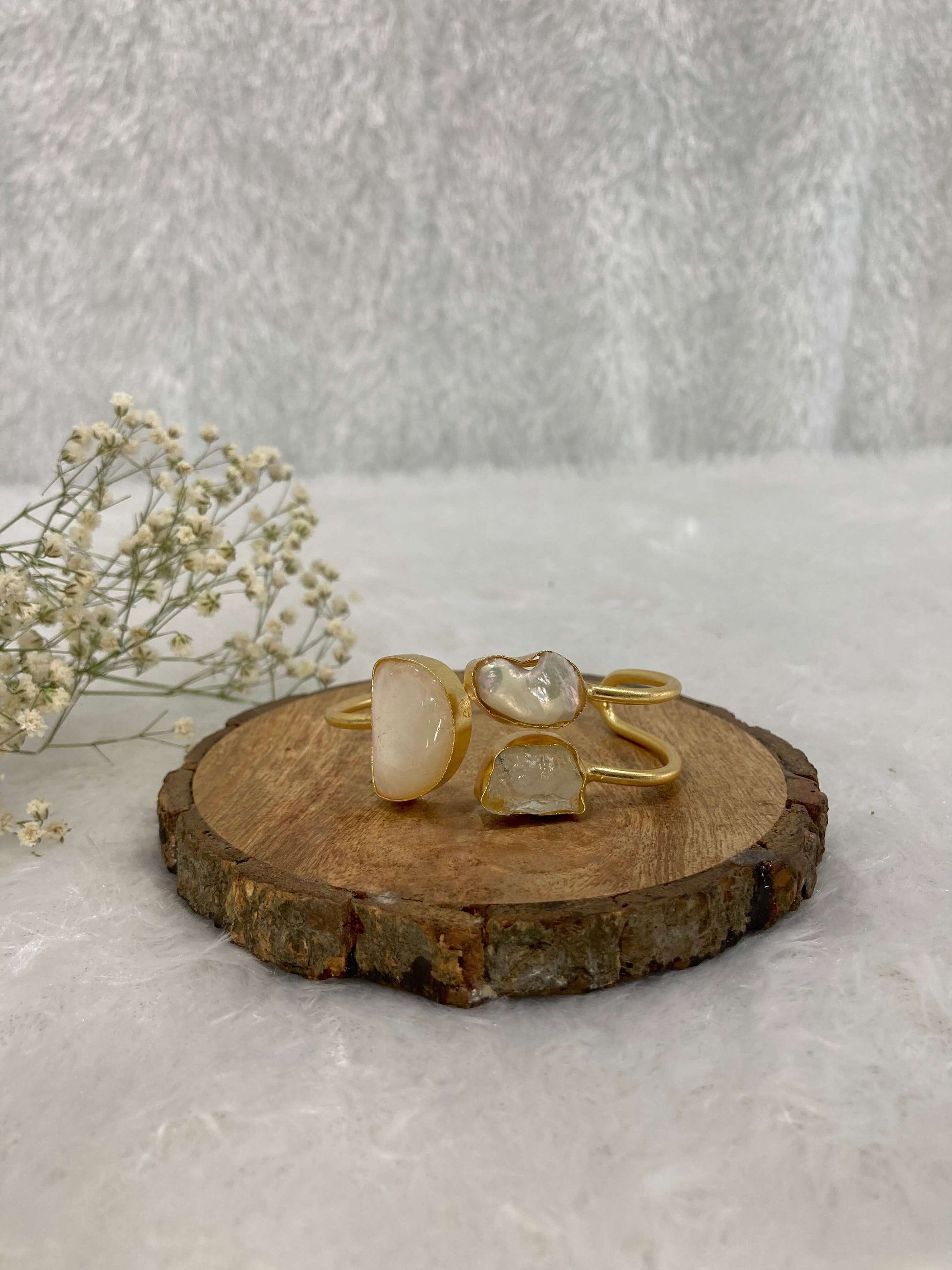 white Stone ear cuff on the wooden base