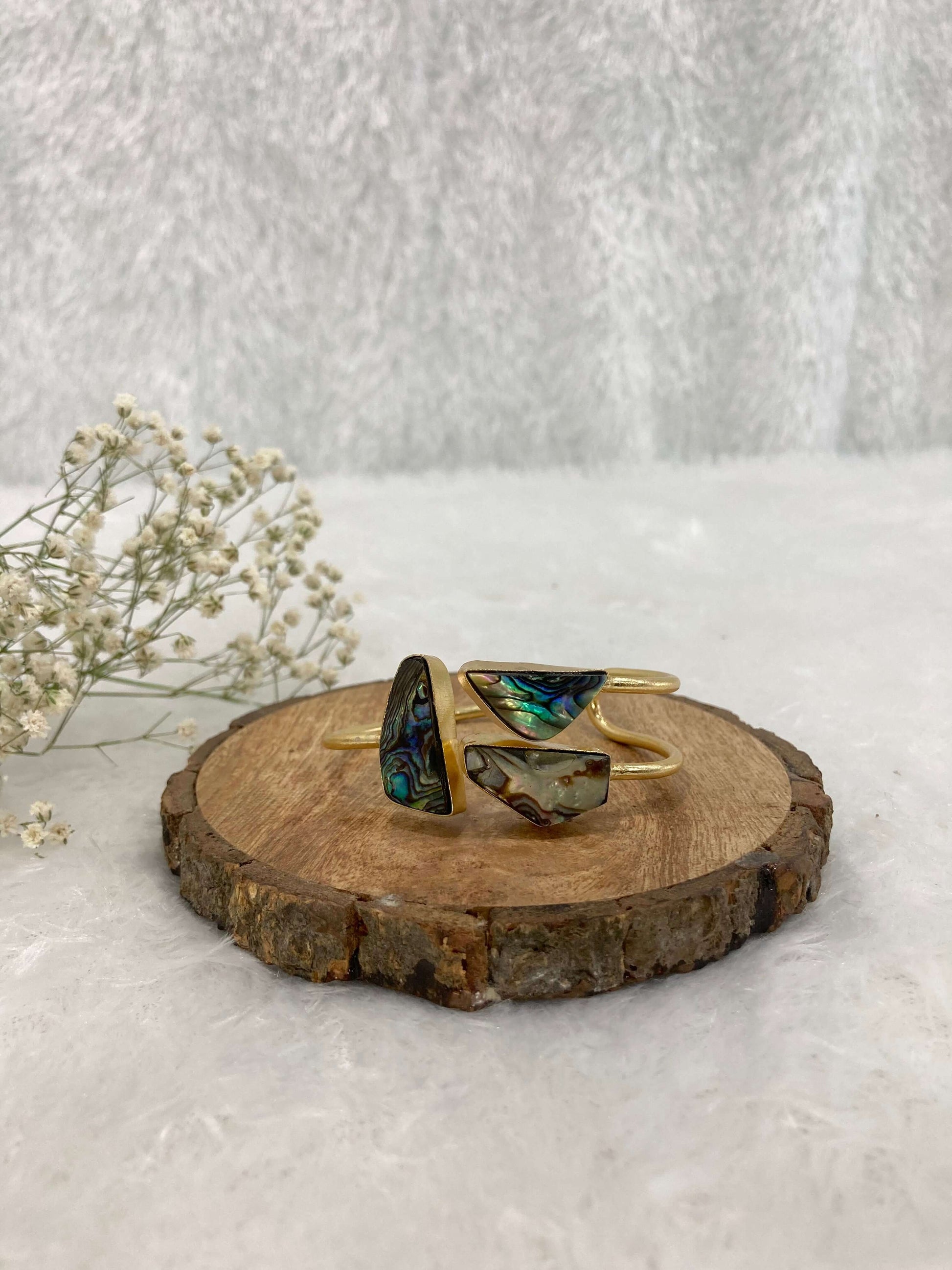multicolor Stone adjustable ear cuff on the wooden base