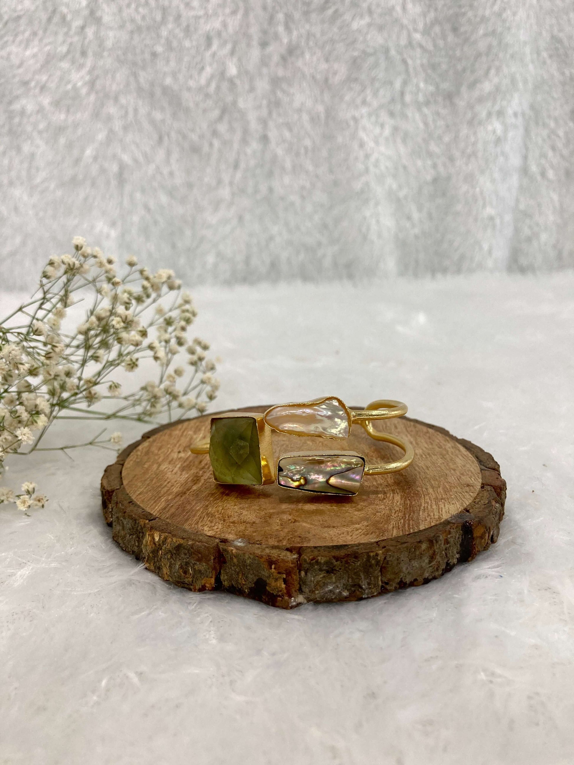 3 Stone adjustable ear cuff on the wood base