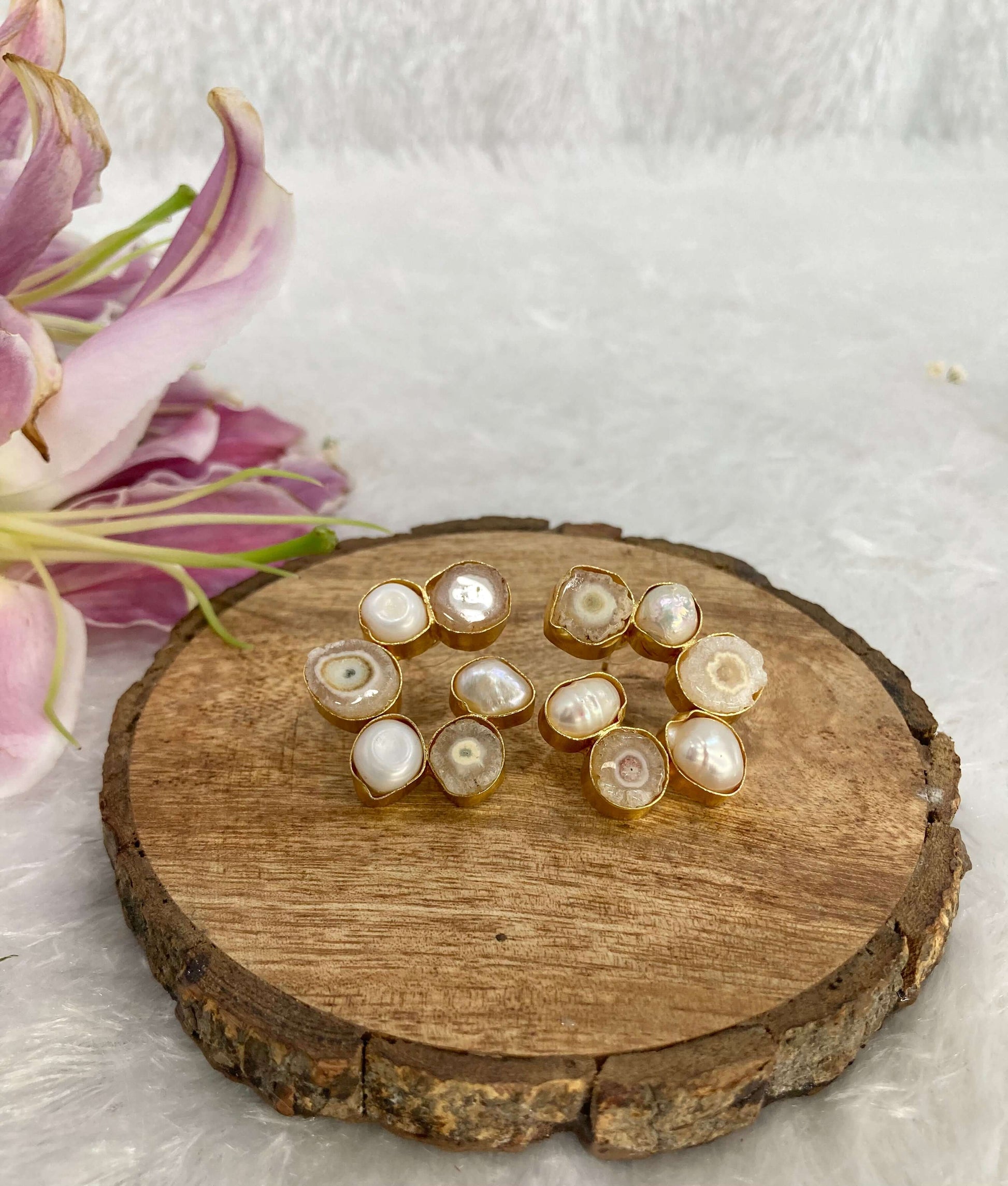 Six white and light coffee stone earrings on the wooden base
