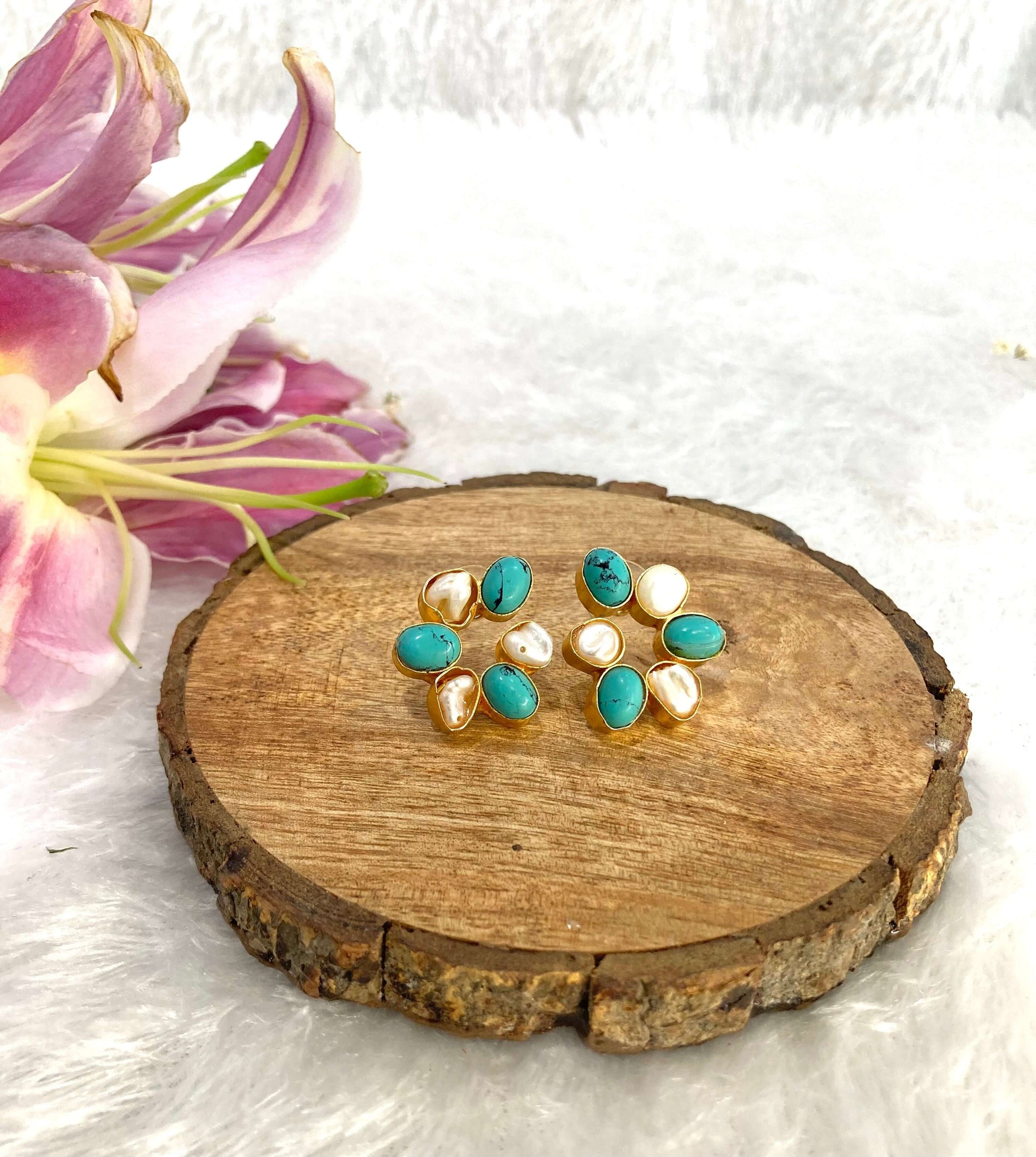 Six white and blue stone earrings on the wooden base