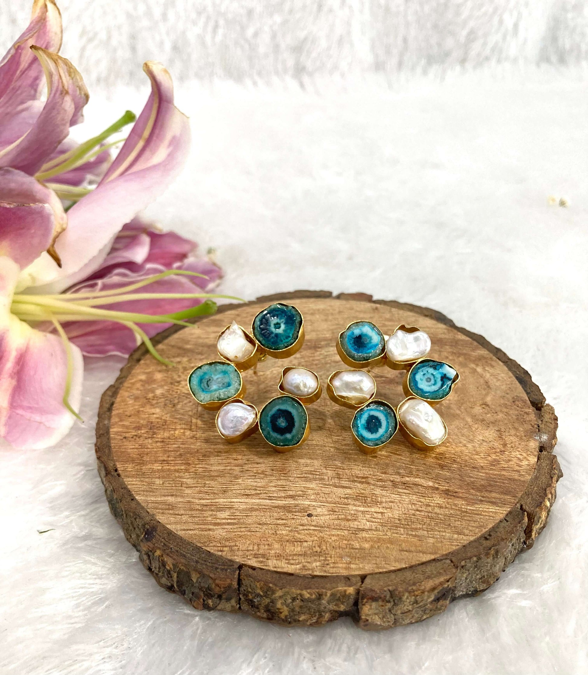Six white and Blue stone earrings on the wooden base