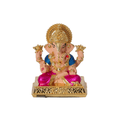 A colorful Dagdushet Ganesha Idol is shown, featuring a gold crown and halo, a blue tunic, and a shiny magenta dhoti. The idol is seated on an ornate gold base and is holding golden lotuses in its upper two hands.