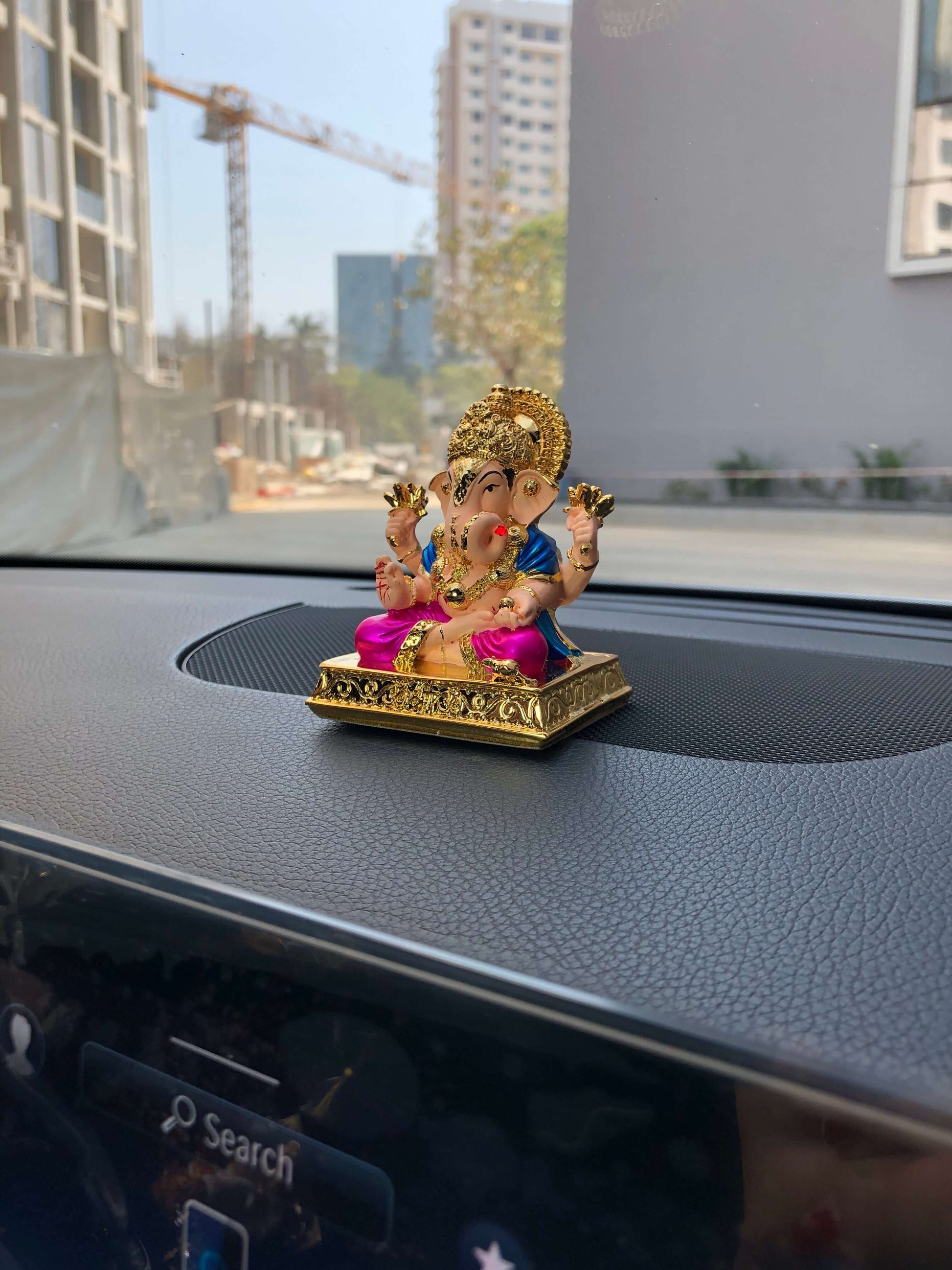 Dagdusheth Ganesh car Idol on the black color car dash dashboard, side angel photo