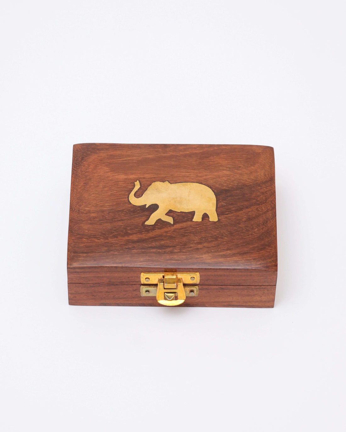 A small, rectangular, handcrafted wooden jewelry box with a brass latch on the front and a brass elephant inlaid on the lid. The wood has a natural grain and a polished finish.