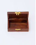 A small, open wooden box with a gold latch is shown on a plain white background. The box is made of dark wood and is empty, revealing a single compartment inside.