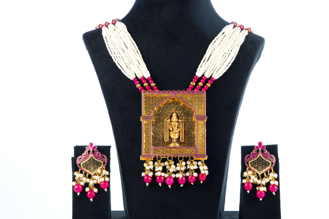 A jewelry set featuring a necklace with pink blossom pendants and a matching pair of earrings, displayed on a mannequin bust.