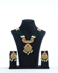 A mannequin showcasing a green and white long Raani haar set, with multiple layers of beads and pearls, along with earrings.