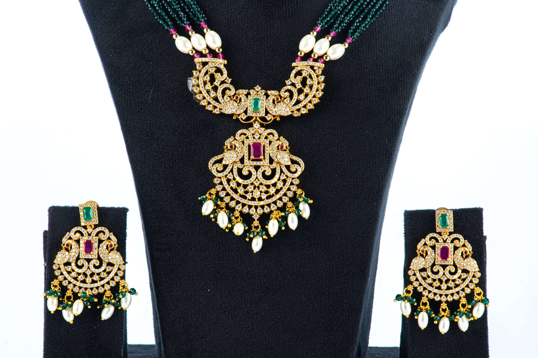 A mannequin showcasing a green and white long Raani haar set, with multiple layers of beads and pearls, along with earrings.