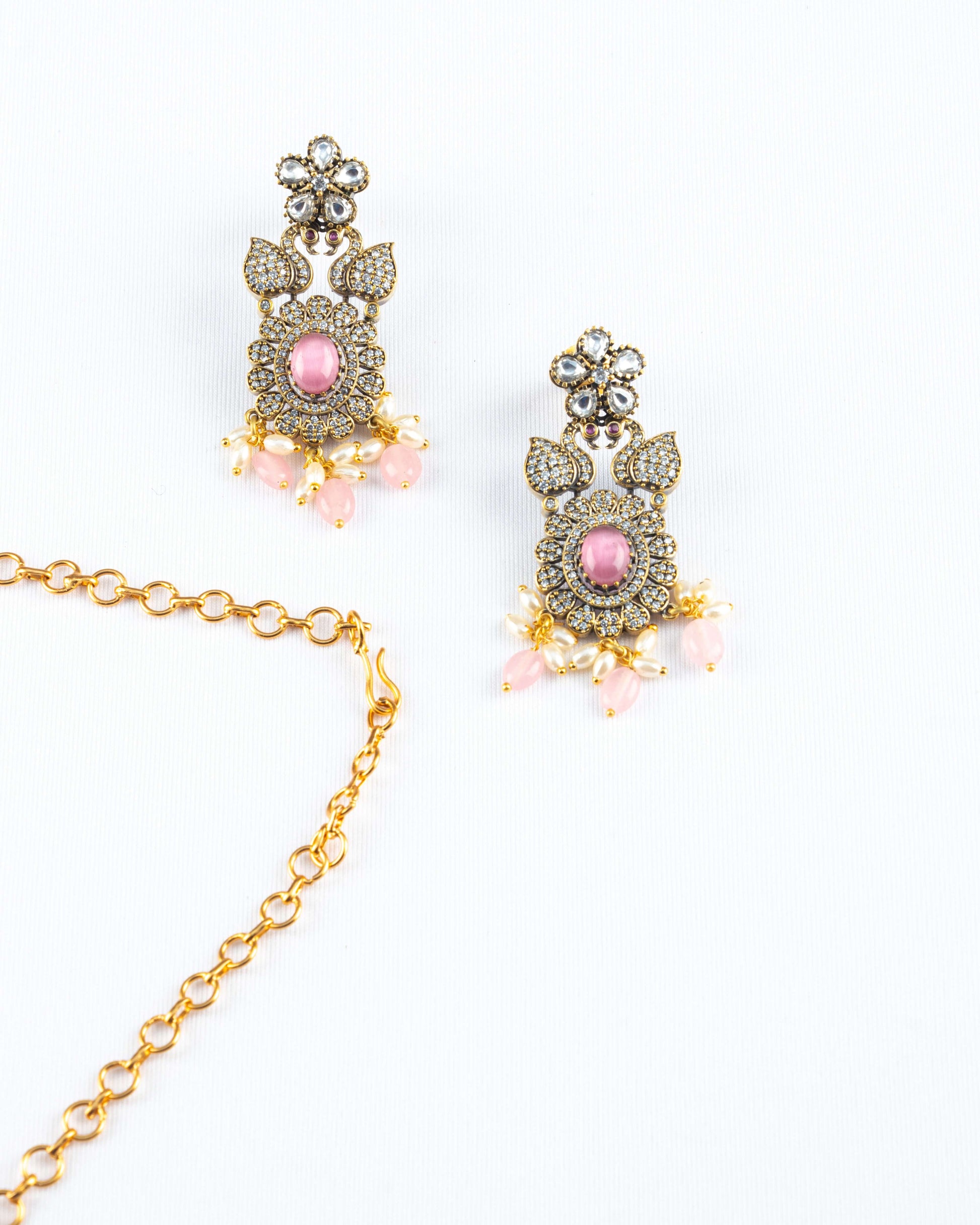A Victorian-style earrings in pink color with gold plated chain