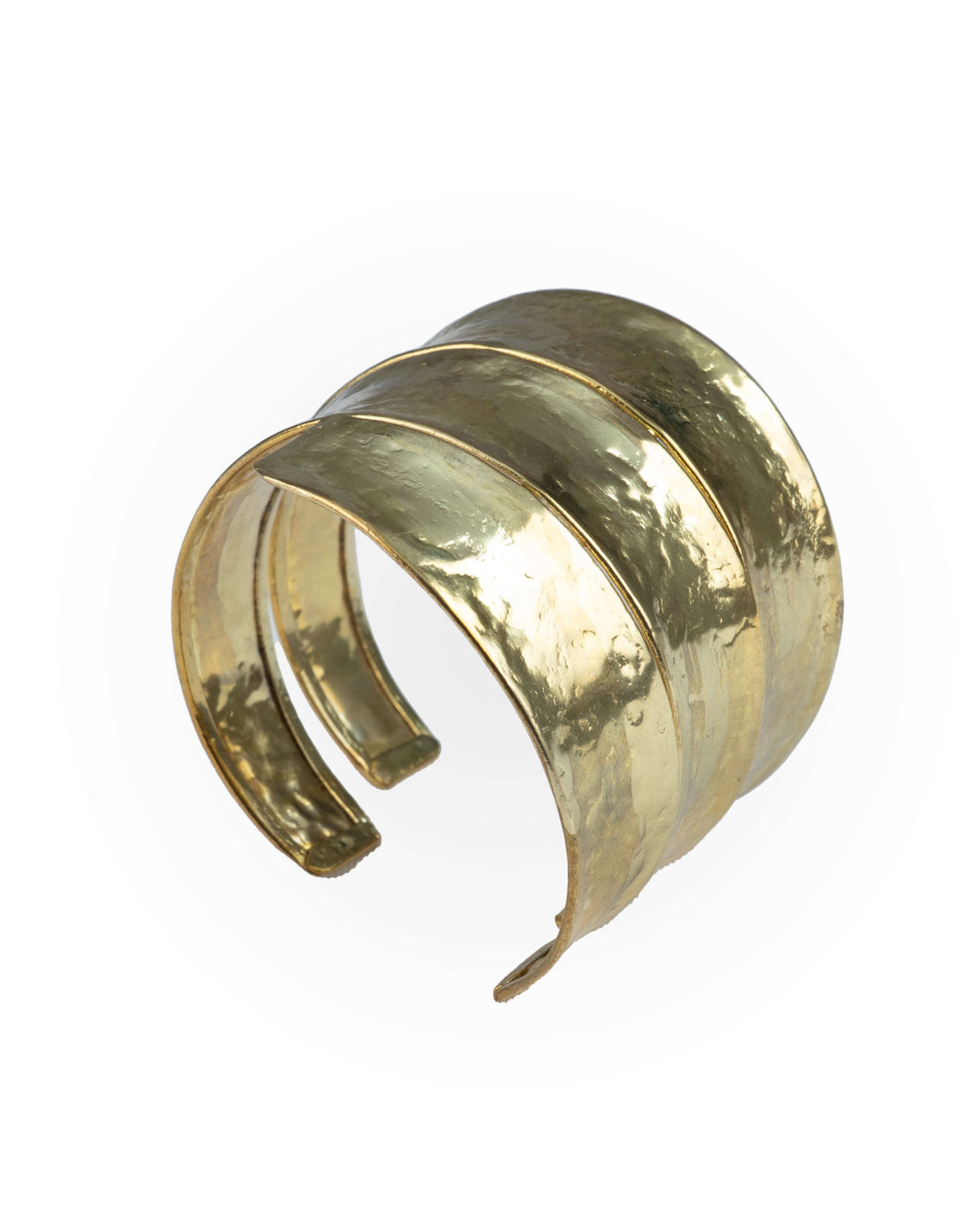 A wrist wearing a twisted gold cuff bracelet with a luxurious shine, showing the bracelet's intricate twists and turns against the wrist.