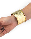 Gold cuff bracelet in hand