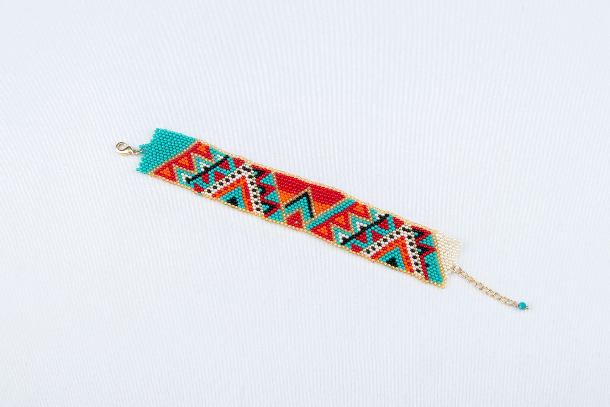 A colorful beaded bracelet on the white base