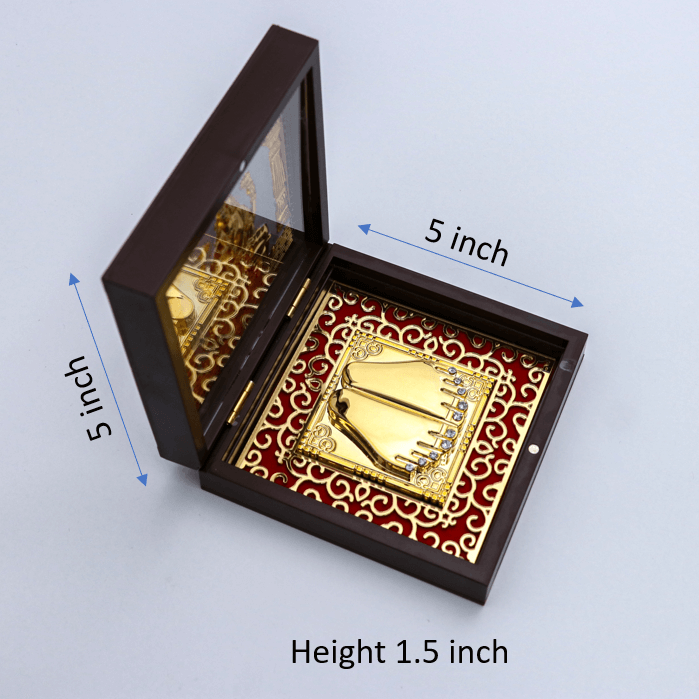 An open, dark wooden box containing a gold-plated Goddess Laxmi Paduka (sacred footprints) set against a red background with an ornate gold pattern. The image is annotated with measurements showing the box is 5 inches by 5 inches with a height of 1.5 inches.