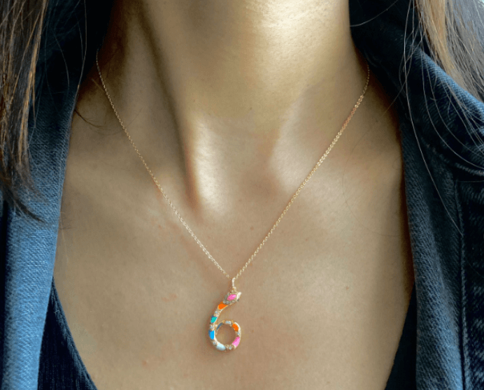 A person wearing a multicolored elegant Number 6 Pendant Necklace with Chain.