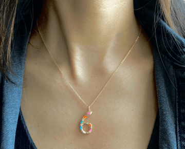 A person wearing a multicolored elegant Number 6 Pendant Necklace with Chain.