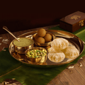 Brass Bhog Thali with besan laddo, rasmalai in bowl, chana sabji with puri