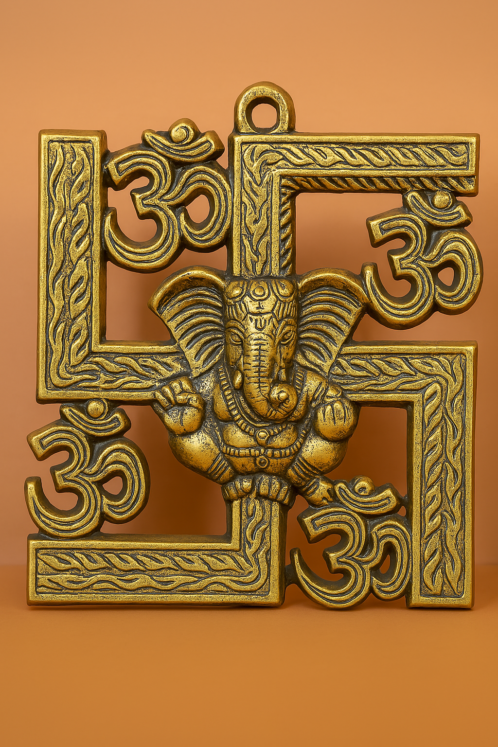 Golden wall hanging featuring Lord Ganesha on a symbol, surrounded by four Om symbols.