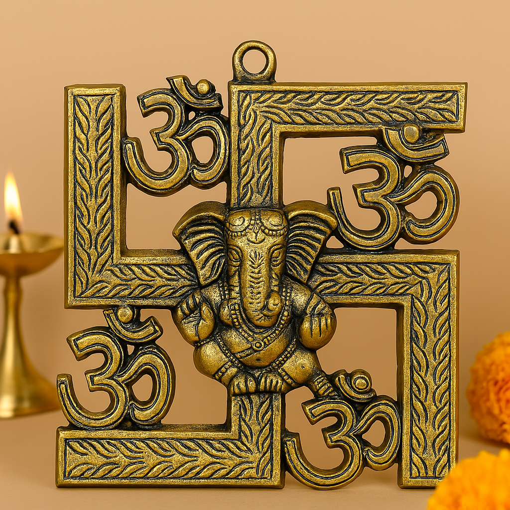 Brass-finished decorative swastika wall hanging with embossed Om symbols and a central Lord Ganesha figure, placed against a warm background with a brass oil lamp and marigold flowers.