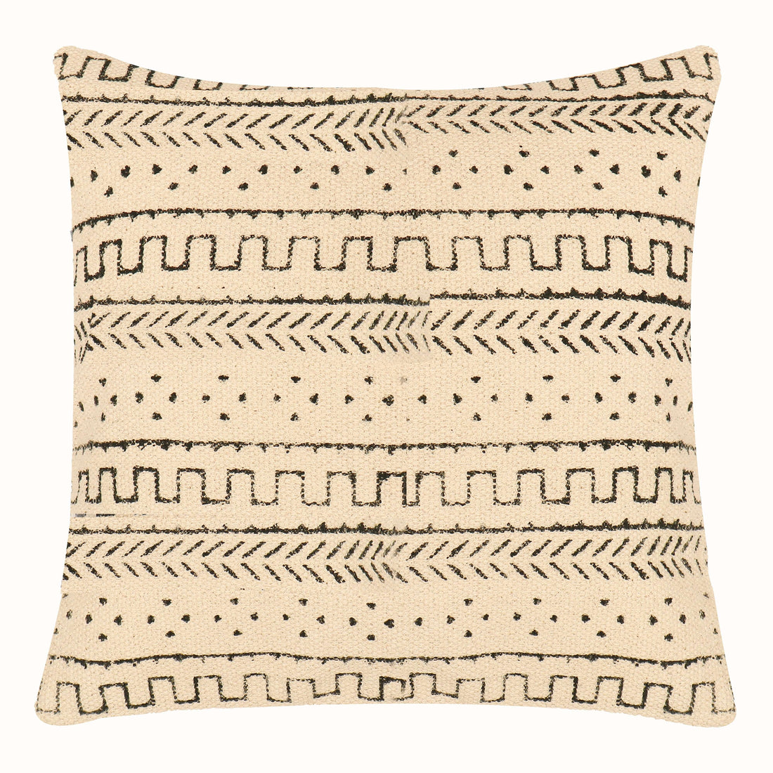 A cushion cover with a tribal geometric pattern on a chair in a room with wooden flooring and white curtains.