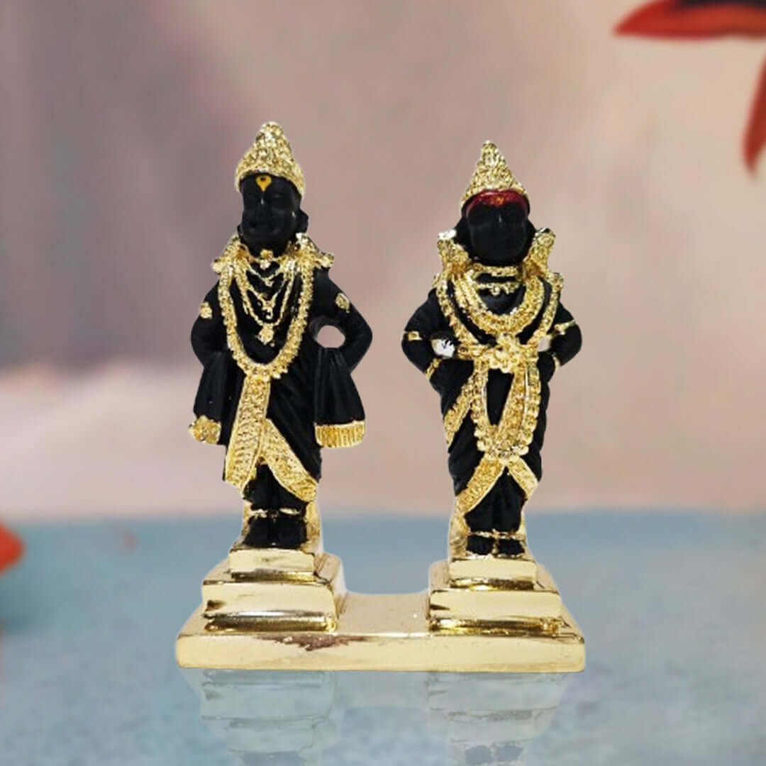 A pair of black and gold polyresin idols depicting the Hindu deities Lord Vitthal and Goddess Rukmini (Rakhumai), adorned with intricate gold-plated jewelry and crowns, standing on a golden base.