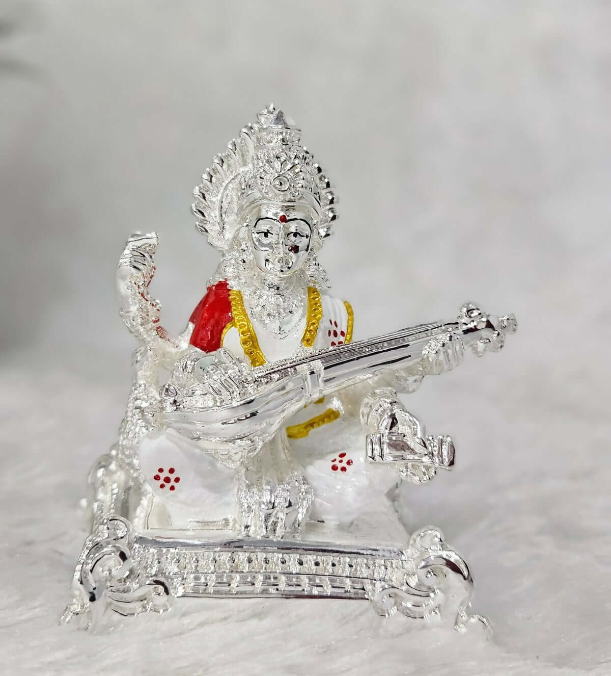 The image displays a Saraswati Mata Idol, a representation of the Hindu Goddess of knowledge, music, art, wisdom, and learning.