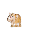 A gold-plated white resin elephant show piece with intricate patterns, displayed against a purple background.