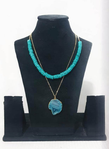 Aqua semi-precious agate stone necklace with a light gold finish displayed on a mannequin bust.