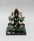 A crystal finish statue of Ganesh, the Hindu deity, with a green and gold color scheme, sitting on a square base.