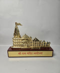 Religious showpiece featuring a miniature Ram Mandir, Ayodhya, with a prominent golden finish and Hindi inscription on the base.