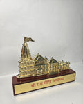Small-scale golden model of the Ayodhya Ram Mandir with intricate detailing and the name of the temple in Hindi on its base.