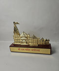 A detailed golden miniature of the iconic Ram Mandir in Ayodhya, presented as a tabletop showpiece.